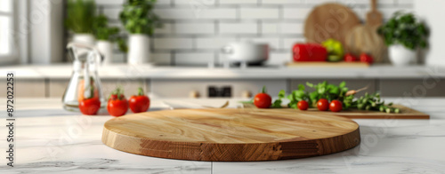 A closeup empty wooden round pizza board placed on the kitchen counter