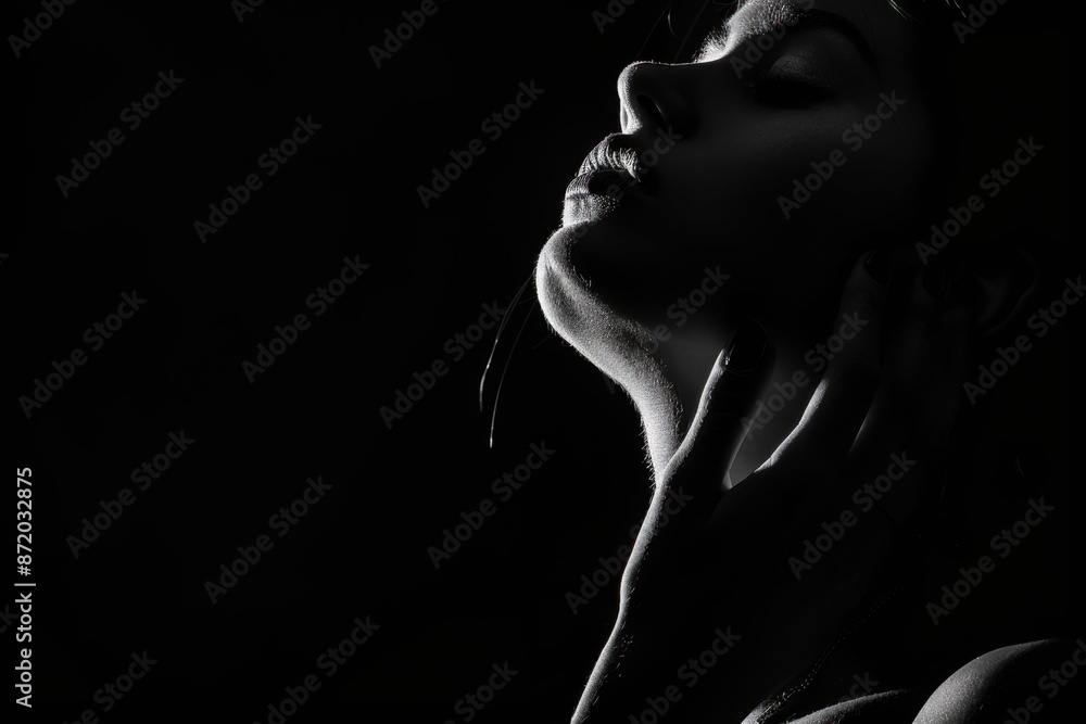 Black and white photo of a woman's silhouette with a hand on her neck, backlit, against an isolated black background Generative AI Black and white photo of a woman's silhouette with a hand on her neck, backlit, against an isolated black background Generative AI