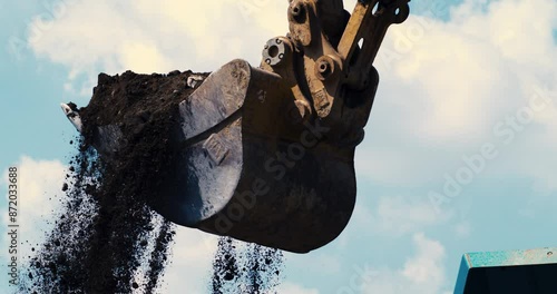 Super slow motion close up of slate concrete debris of demolition of roads and building falling from excavator during quality control and sorting process at landfills plant industrial factory,1000 fps