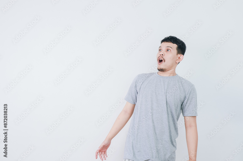 Surprised shocked face asian man isolated on white background for advertisement. Surprised shocked face asian man isolated on white background for advertisement.