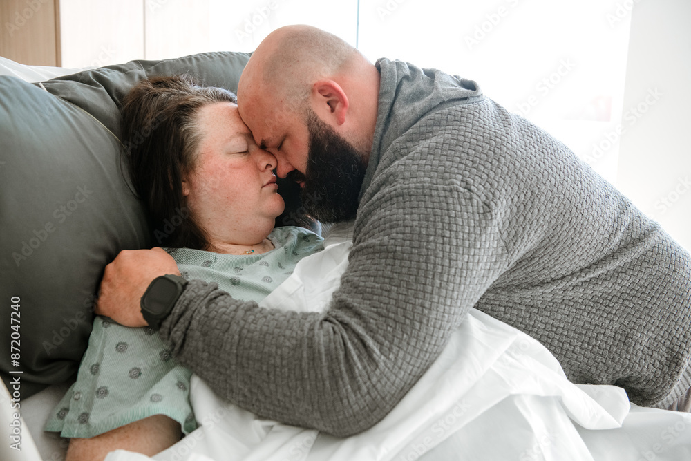 Man and wife touching foreheads before meeting their child. Man and wife touching foreheads before meeting their child.