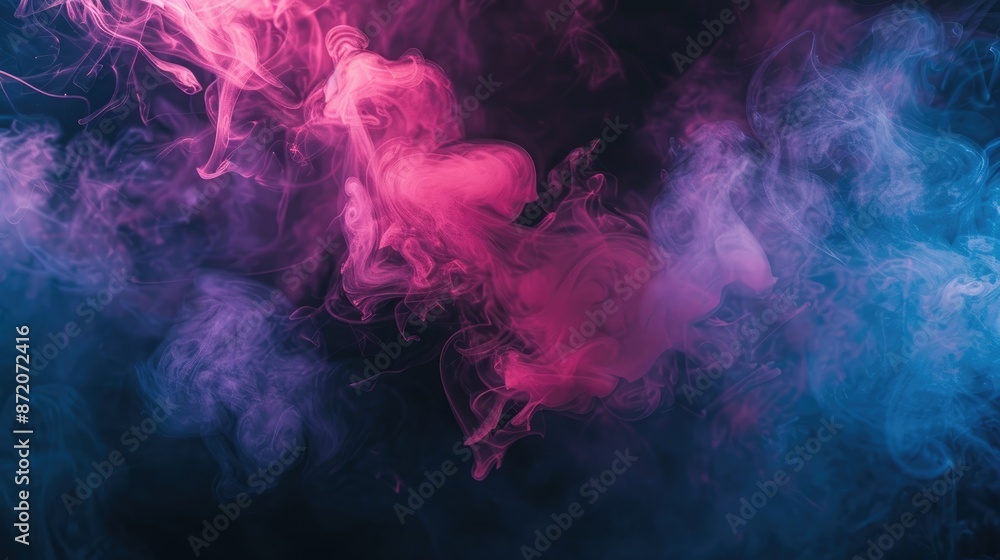 Fototapeta premium Moody and atmospheric image of ethereal pink and blue smoke against a deep black background, perfect for dramatic visual effects