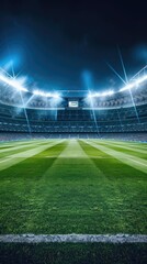 A green soccer field at night, illuminated by bright stadium lights, with the goal in the background