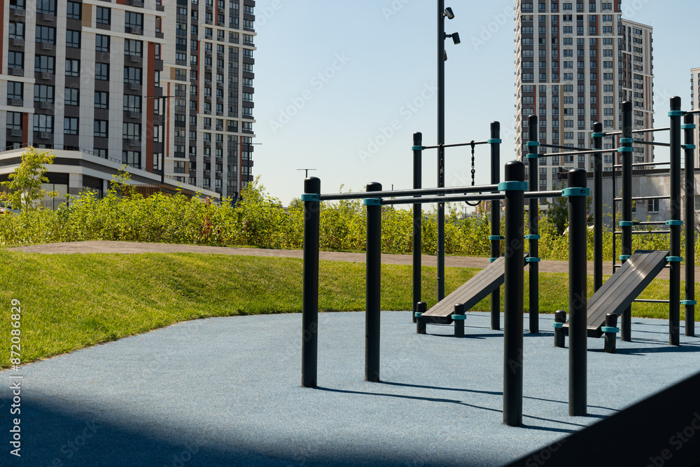 Modern sports playground or gym park for fitness exercises in the city at summer. Outdoors. Public stadium zone. Gym park in courtyard. Modern sports playground or gym park for fitness exercises in the city at summer. Outdoors. Public stadium zone. Gym park in courtyard.