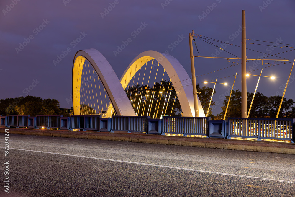 Fototapeta premium illuminated tram stop with a bridge in Lyon at night