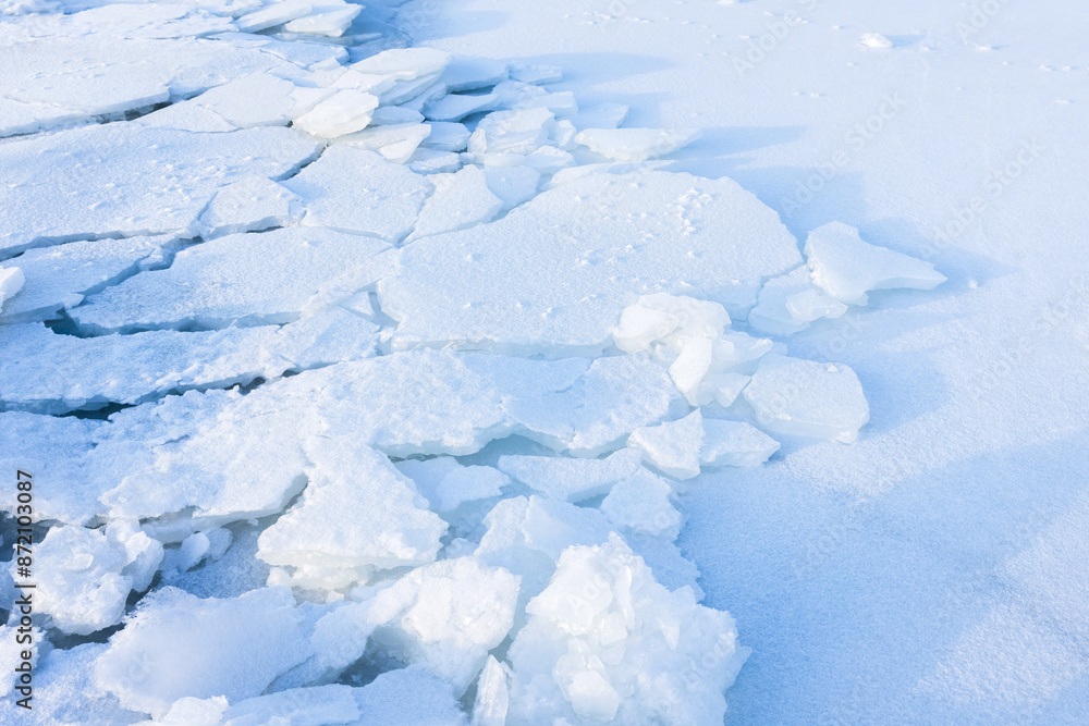 Cracked ice hummocks covered with white snow. Broken ice fragments Cracked ice hummocks covered with white snow. Broken ice fragments