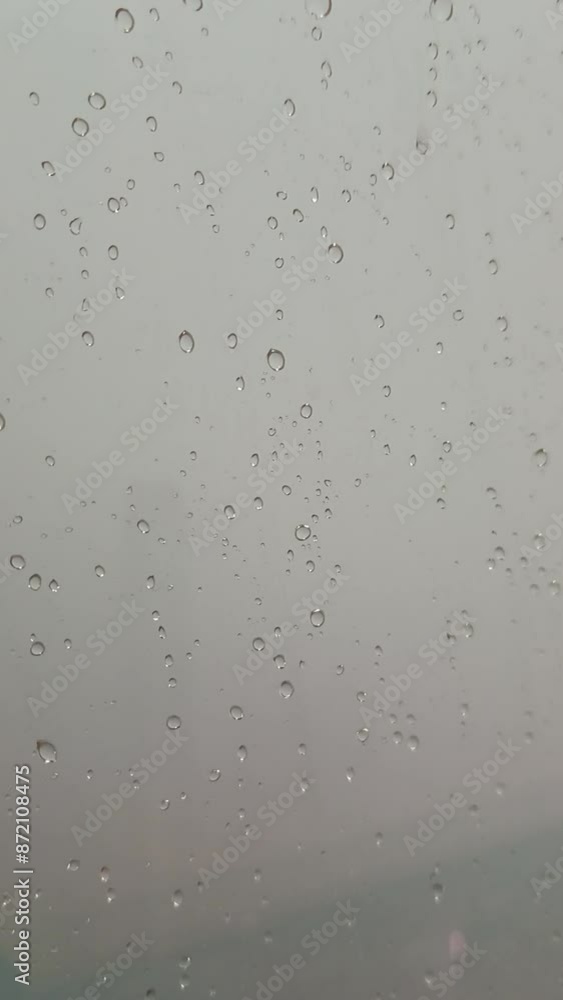 Raindrop falls from the sky, captured in extreme close-up as it descends. Raindrop falls from the sky, captured in extreme close-up as it descends.