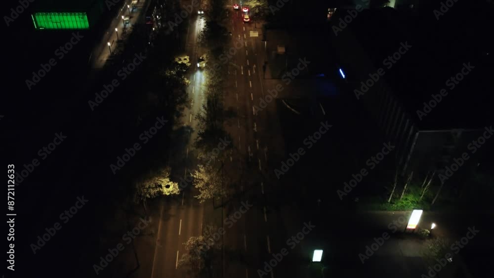 Cinematic Drone Shot of a Multi-Lane Street at Night in a Bustling City with Cars Passing By, Illuminated by Street Lights, Showcasing Urban Traffic and Nocturnal Activity Cinematic Drone Shot of a Multi-Lane Street at Night in a Bustling City with Cars Passing By, Illuminated by Street Lights, Showcasing Urban Traffic and Nocturnal Activity