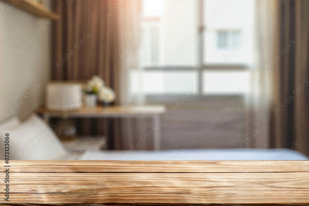 Empty wooden table top on blurred background of modern bedroom interior with big window Empty wooden table top on blurred background of modern bedroom interior with big window