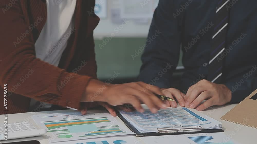 Business meeting time,business account managers crew working with new startup project,report analysis cost graph on desk at meeting room. Business meeting time,business account managers crew working with new startup project,report analysis cost graph on desk at meeting room.