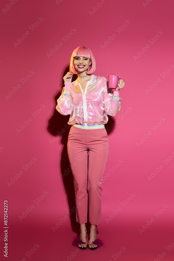 A woman in a pink outfit, with pink hair, smiles while holding a pink cup. A woman in a pink outfit, with pink hair, smiles while holding a pink cup.
