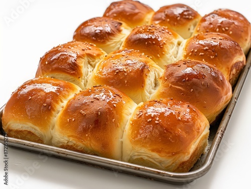 tray of golden-brown white dinner rolls, fresh from the oven, with a soft and airy interior.