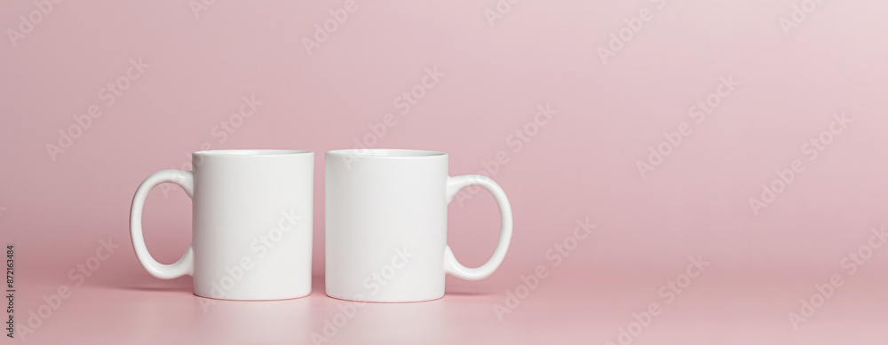 white cups for tea or coffee on a pink background white cups for tea or coffee on a pink background