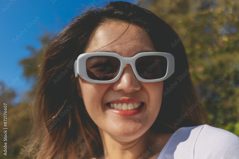 Close up of cheerful asian woman happy to be outdoor on the beach. Close up of cheerful asian woman happy to be outdoor on the beach.