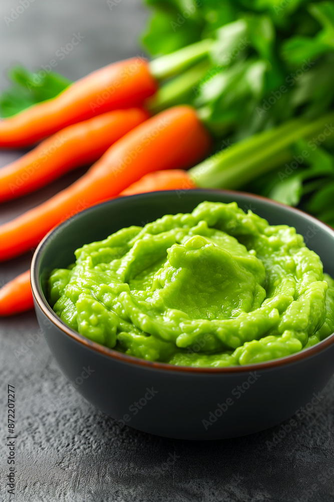 A close-up photo capturing the smoothness of mashed avocados blending into the chunkiness of pureed carrots in baby food development A close-up photo capturing the smoothness of mashed avocados blending into the chunkiness of pureed carrots in baby food development