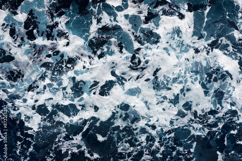 Obraz premium Ocean wave background. Bubble water backdrop. Turbulent sea texture. Messy water flow. Depth of the sea. Water foam surface backdrop. Rapid river flow.