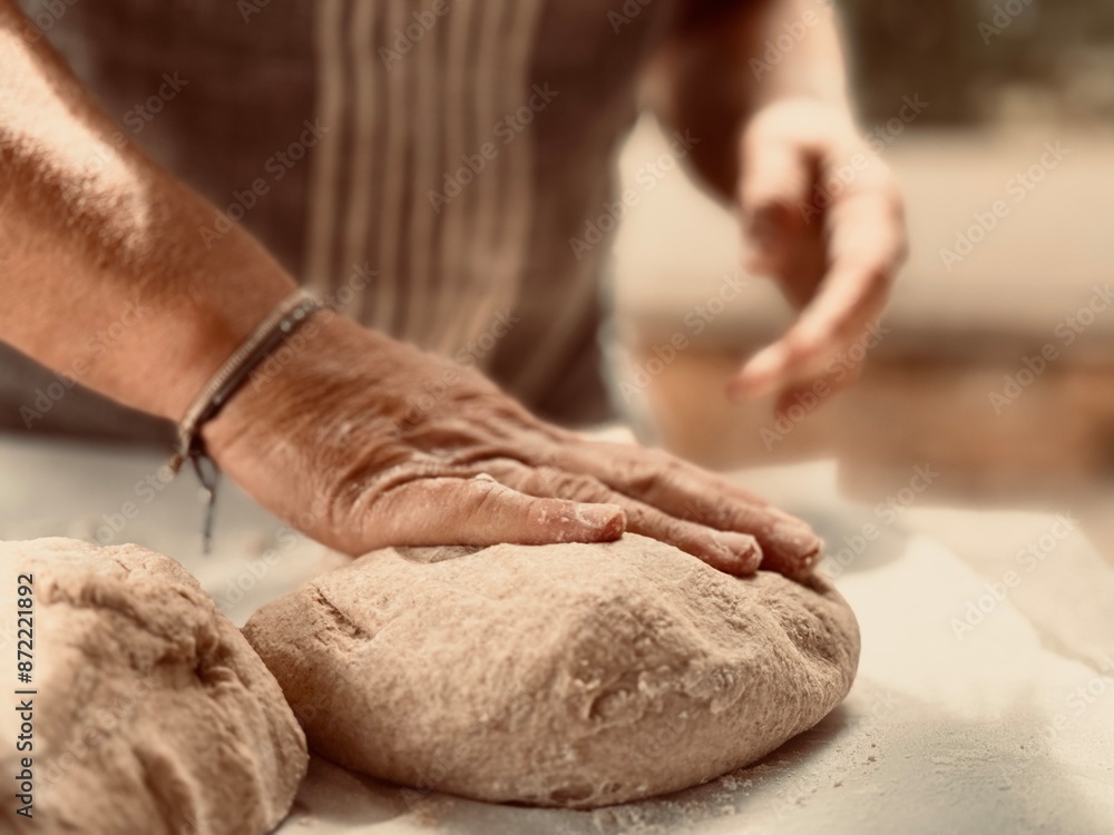 Artisan baker kneading the dough.
Artisan baker kneading the dough.
