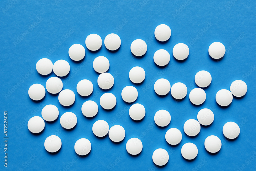 A white and blue with pills. Pharmacy pill medicine concept. Round white pills in blue on a. Round of pills in blue and lifestyle white on a. A white and blue with pills. Pharmacy pill medicine concept. Round white pills in blue on a. Round of pills in blue and lifestyle white on a.