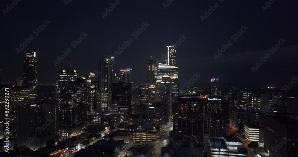 Aerial of Austin, Texas downtown area cityscape with glowing lights on the buildings at night Aerial of Austin, Texas downtown area cityscape with glowing lights on the buildings at night