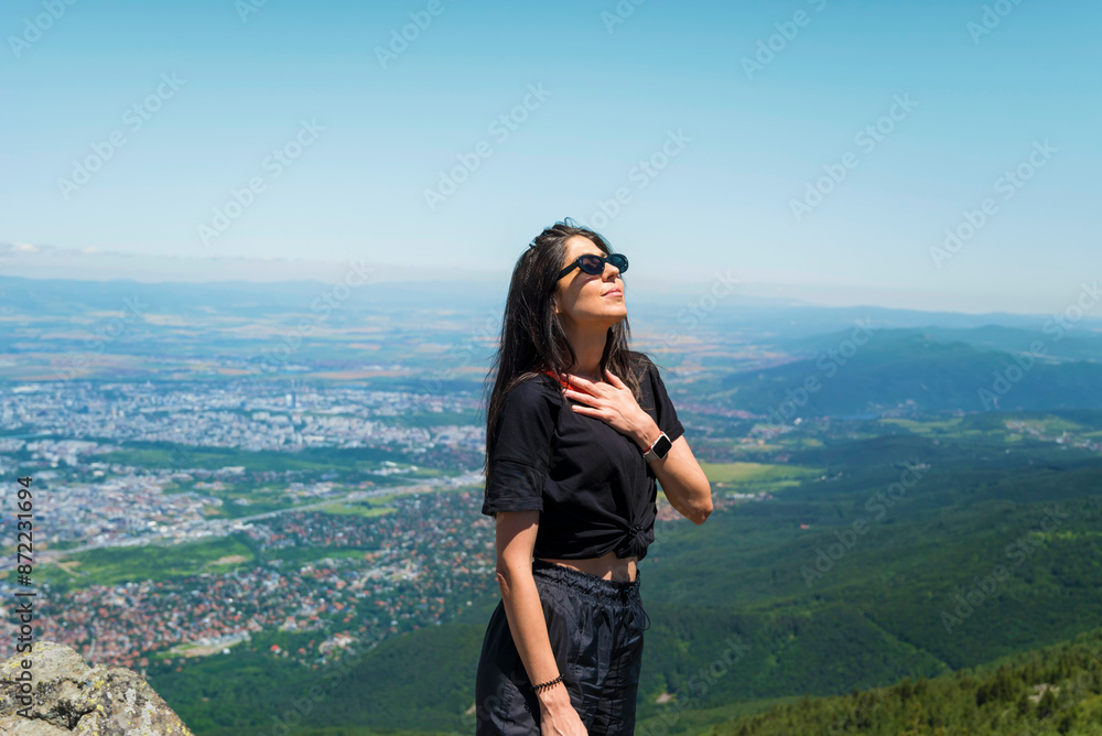 Naklejka premium Relaxed woman breathing fresh air in the spring mountain
