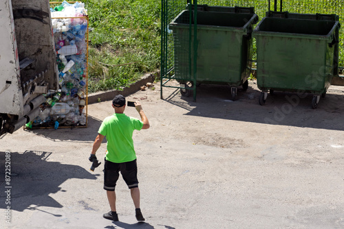 A representative of the sanitary service monitors the quality of cleaning and disinfection of garbage tanks. Quality of waste disposal.