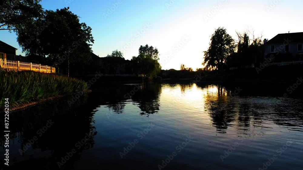 Aerial Beautiful Shot Of River Amidst Trees Against Clear Sky, Drone Ascending Forward During Sunset - Valencia, California