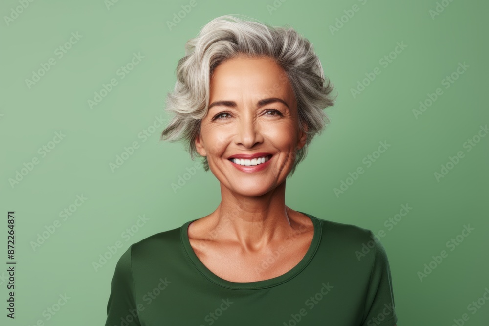 Cheerful senior woman with grey hair. Isolated on green background Cheerful senior woman with grey hair. Isolated on green background