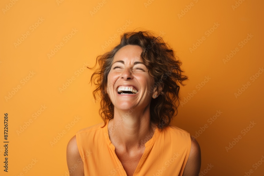 Portrait of a beautiful happy woman laughing on a yellow background. Portrait of a beautiful happy woman laughing on a yellow background.