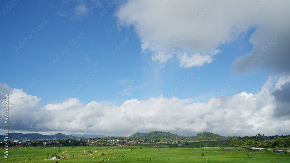 beautiful scenery, rice fields, villages and mountains with blue sky and white clouds in Tompaso, North Sulawesi, Indonesia beautiful scenery, rice fields, villages and mountains with blue sky and white clouds in Tompaso, North Sulawesi, Indonesia
