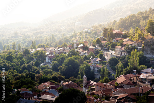 Sunlight illuminating houses of a village nestled in the troodos mountains of cyprus photo