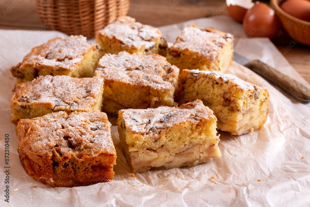 Traditional apple pie on a white plate on a wooden table. Charlotte pie on a platter. Delicious homemade pastry on the table. Traditional apple pie on a white plate on a wooden table. Charlotte pie on a platter. Delicious homemade pastry on the table.