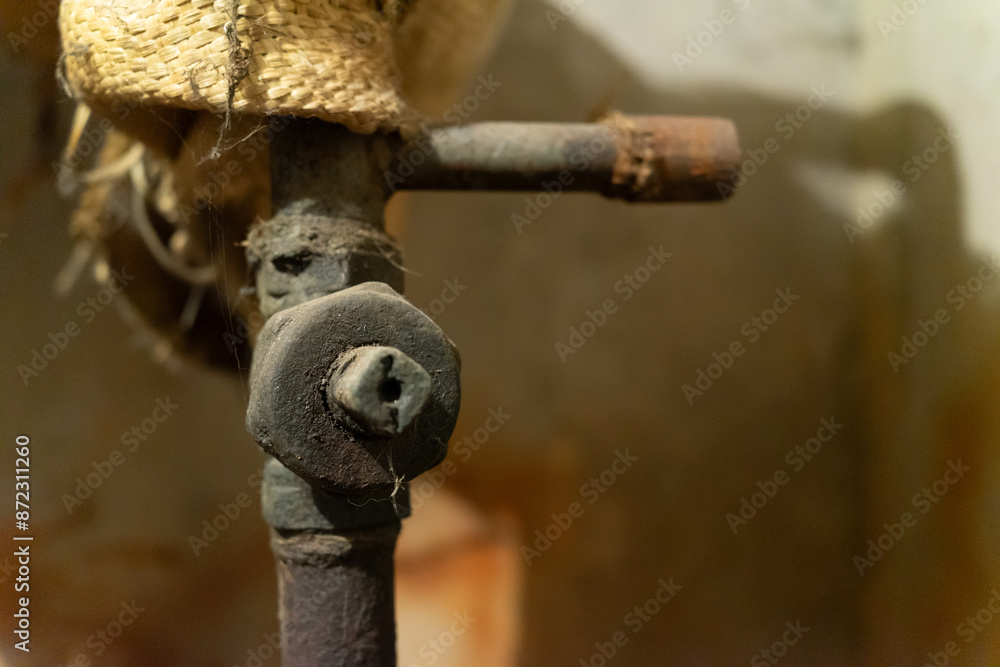 Antique rusty shut-off valve in basement Antique rusty shut-off valve in basement