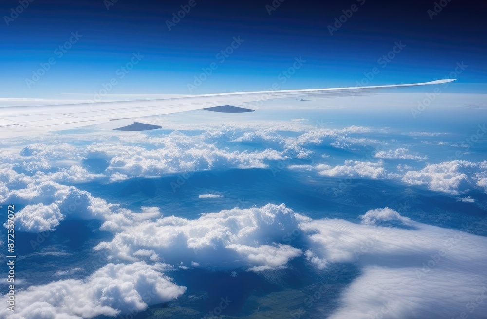 Banner. View from the airplane window to the clouds, blue sky and airplane wing. Travel concept. Banner. View from the airplane window to the clouds, blue sky and airplane wing. Travel concept.