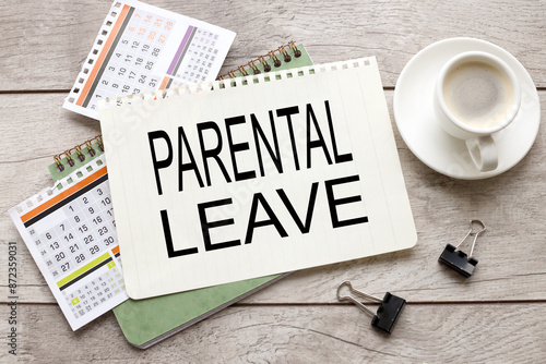 parental leave text on notepad sheet on calendar pages