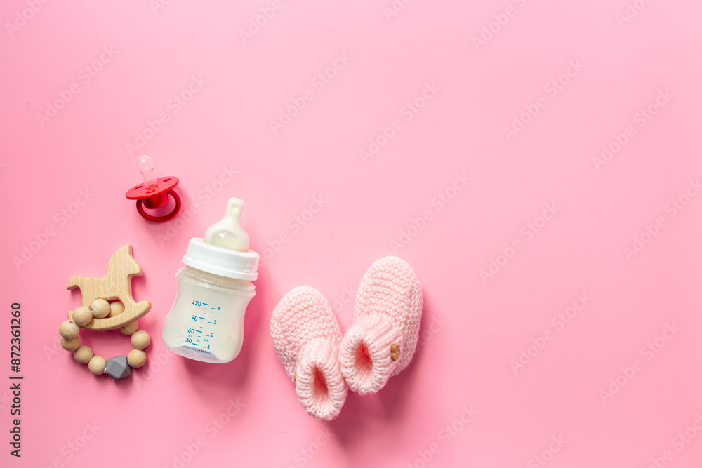 Baby kids food and toy. Milk in bottle with child accessories, top view Baby kids food and toy. Milk in bottle with child accessories, top view