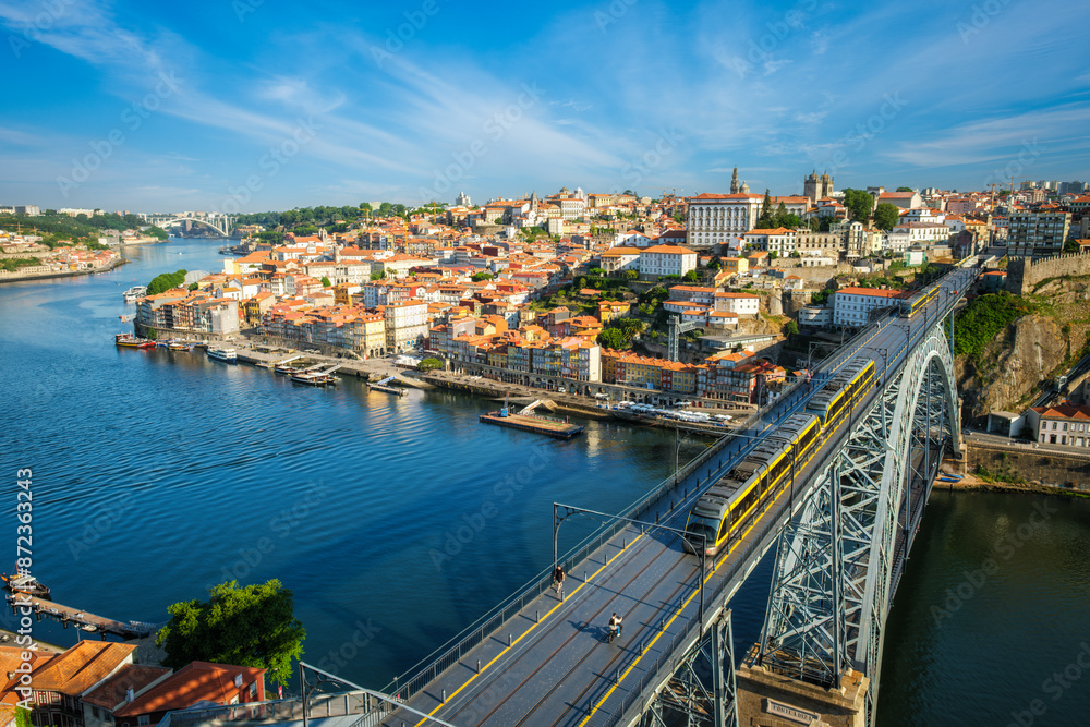 Fototapeta premium View of Porto city and Douro river and Dom Luis bridge I with metro tram from famous tourist viewpoint Miradouro da Serra do Pilar. Porto, Vila Nova de Gaia, Portugal