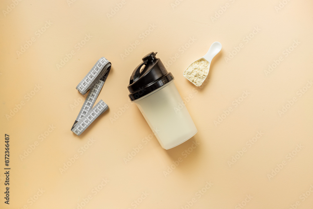 Protein shaker for sports nutrition. Whey protein powder in a scoop, top view Protein shaker for sports nutrition. Whey protein powder in a scoop, top view