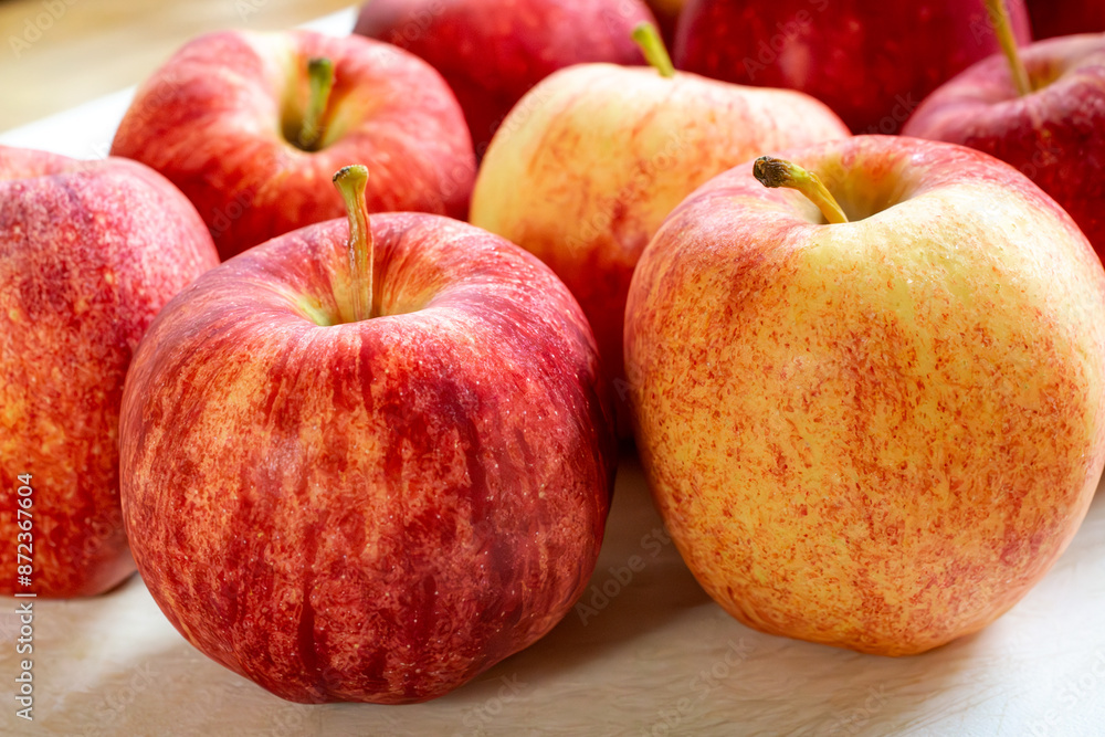 Gala apples on a white cutting board. Gala apples on a white cutting board.
