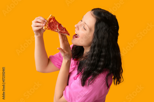 Young woman eating tasty pi...