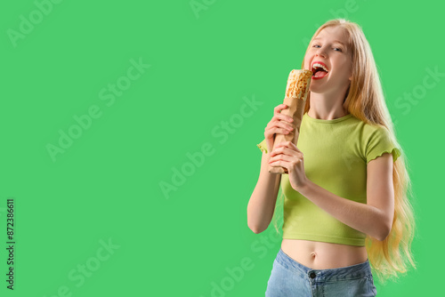 Young woman eating doner ke...