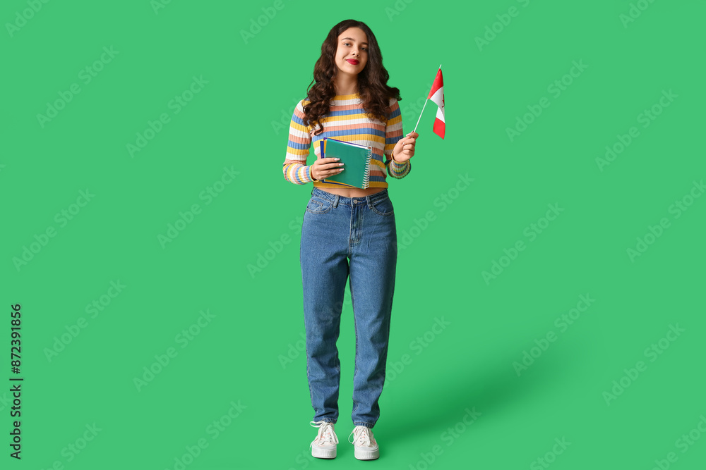 Female student with notebook and flag of Canada on green background Female student with notebook and flag of Canada on green background