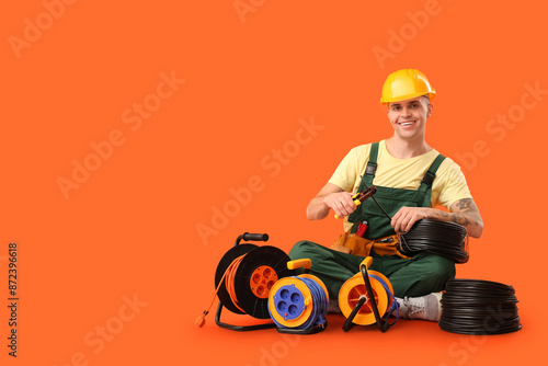 Young male electrician with...