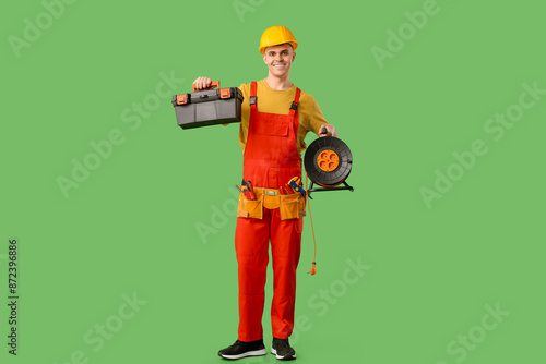 Smiling electrician in over...