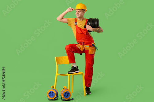 Young male electrician with...