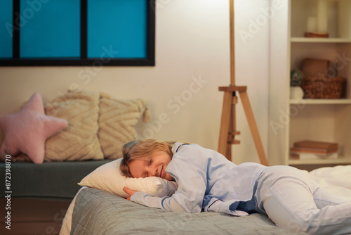 Adorable girl sleeping on cozy bed