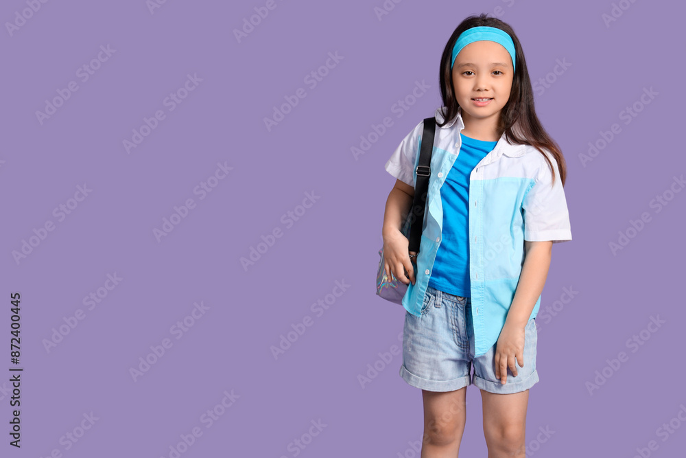 Portrait of fashionable little girl with backpack on lilac background Portrait of fashionable little girl with backpack on lilac background