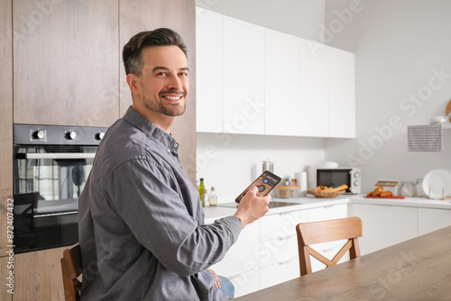 Young man using mobile phon...
