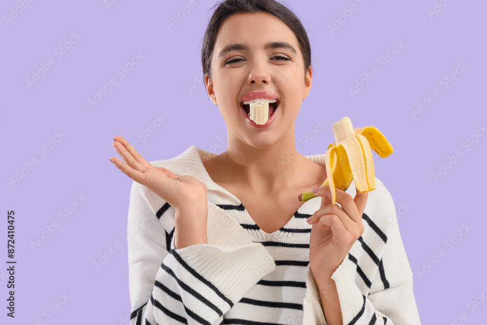 Young woman eating banana on lilac background, closeup Young woman eating banana on lilac background, closeup