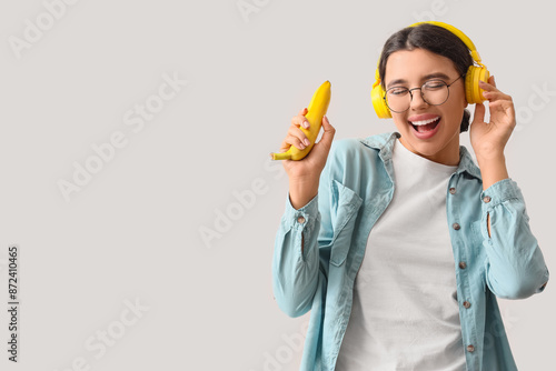 Happy young woman in headph...