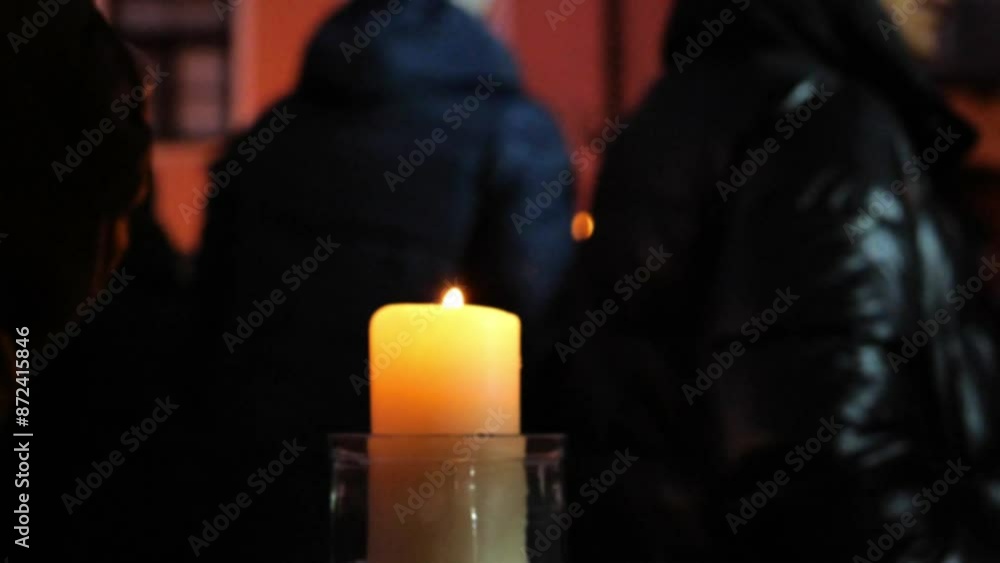 Burning candle and walking people in blurry focus.Christmas markets crowd in blur.cozy festive atmosphere. 4k footage Burning candle and walking people in blurry focus.Christmas markets crowd in blur.cozy festive atmosphere. 4k footage